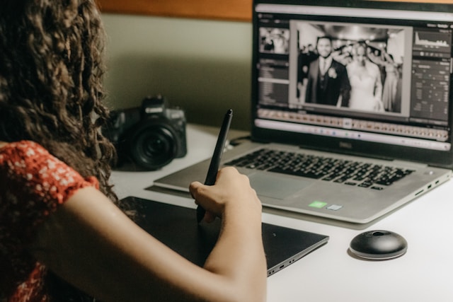 Creative professionals reviewing and organising photos on a desktop using advanced photo editing software for professionals