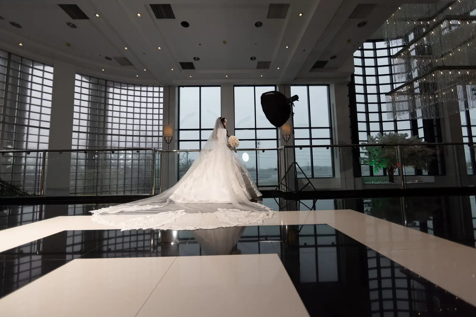 Before editing: Raw indoor bridal portrait with a light stand and overexposed window light