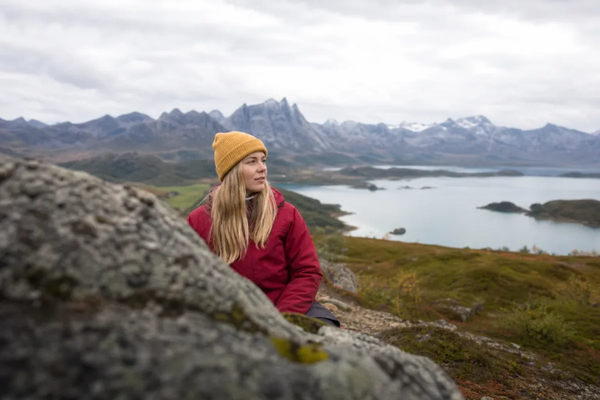 Travel portrait balanced by foreground rocks, a middle-ground subject, and distant landscape layers