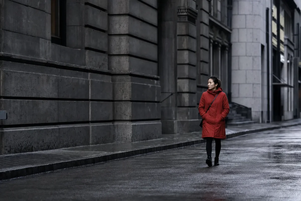 focal point contrast red jacket Red jacket subject standing out as a focal point against a gray city street
