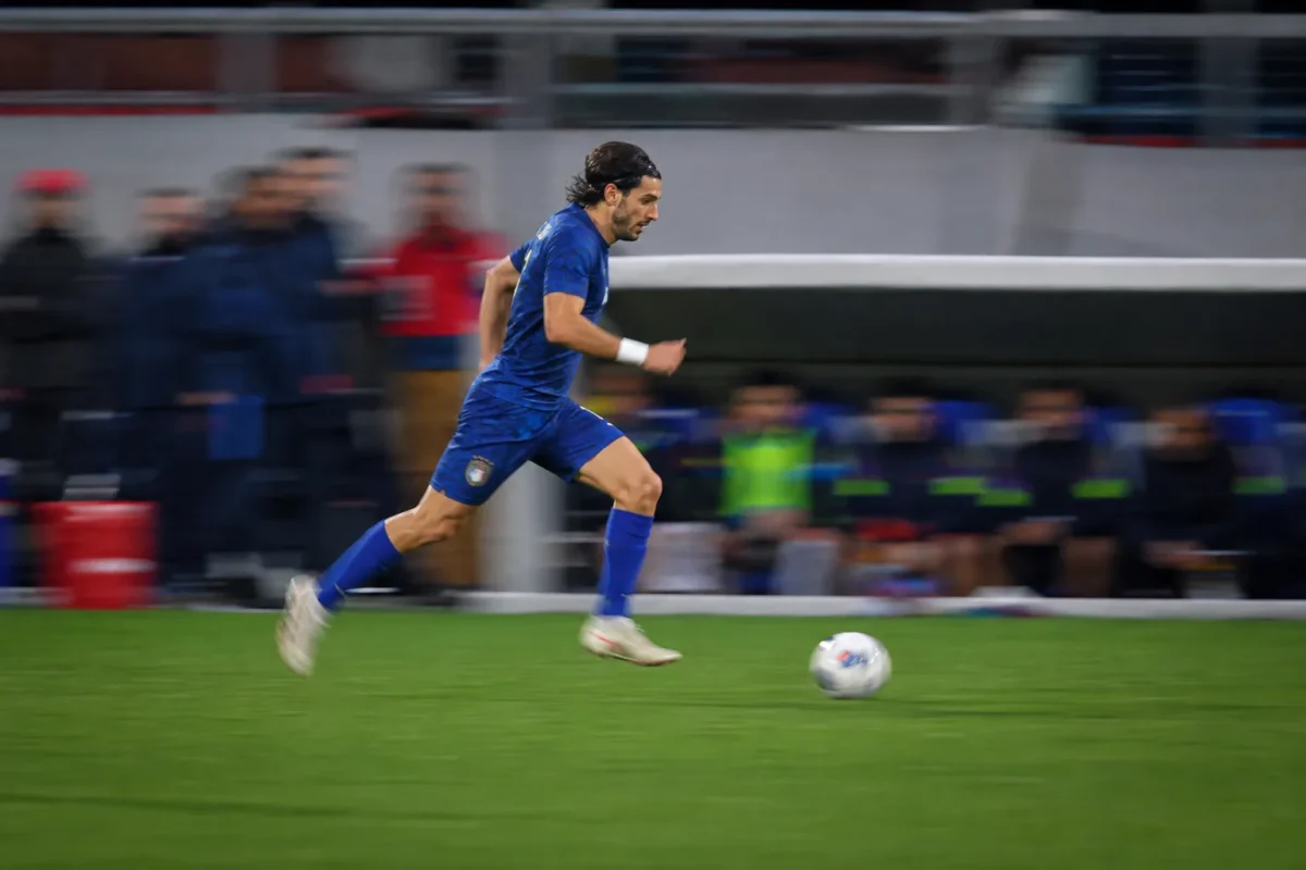 Soccer player sprinting with controlled panning motion blur