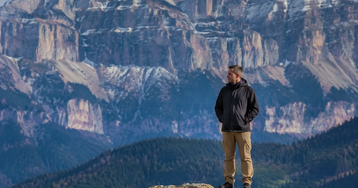 Portrait with visible foreground-to-background layering to show what lens compression looks like when distant background elements appear visually closer to the subject