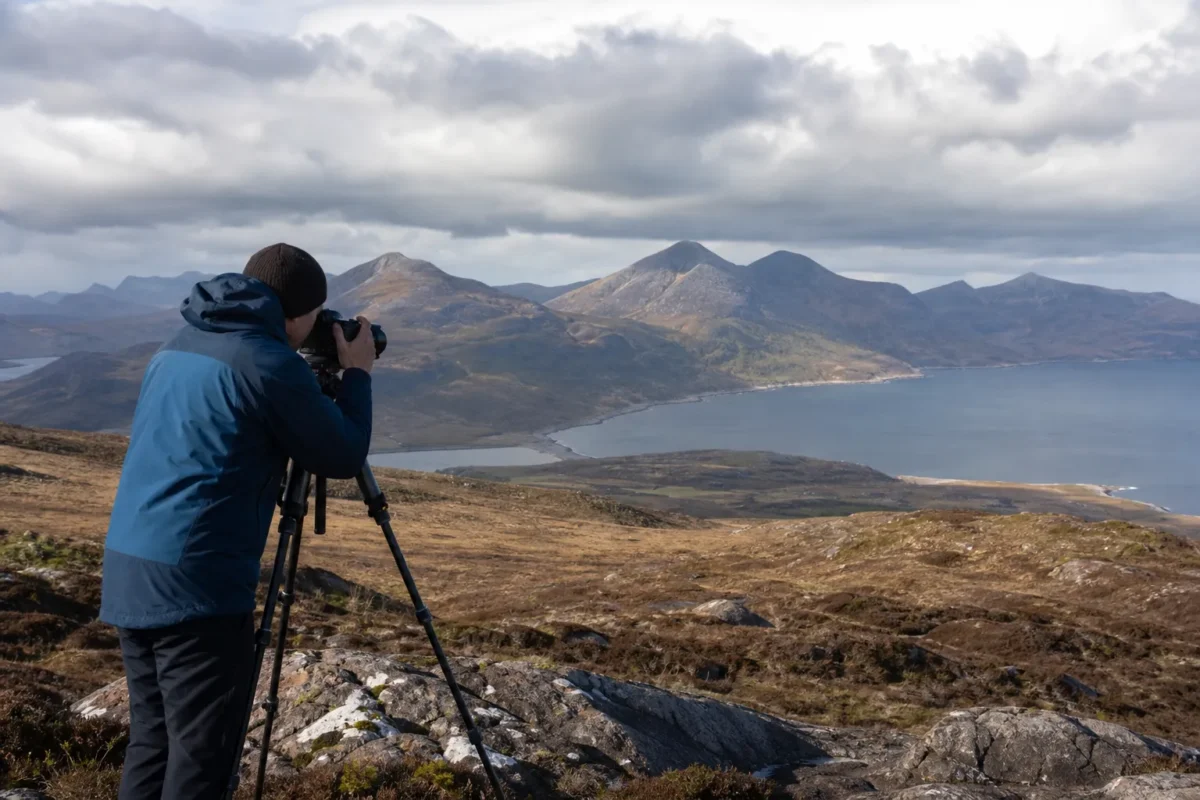 Landscape photographer using a tripod and smaller aperture for deeper depth of field