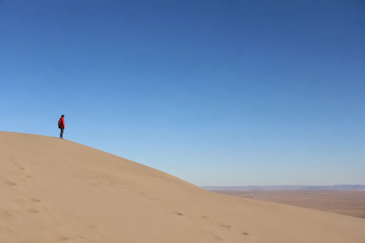 Minimal travel image with a small subject on a third line and clean negative space filling the rest of the frame