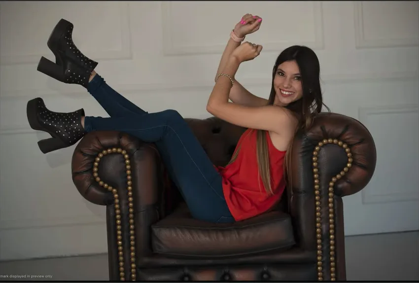 Crooked underexposed studio couch portrait before editing in Evoto