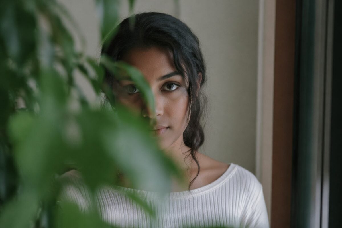 Portrait where a foreground branch blocks the face and distracts from the subject