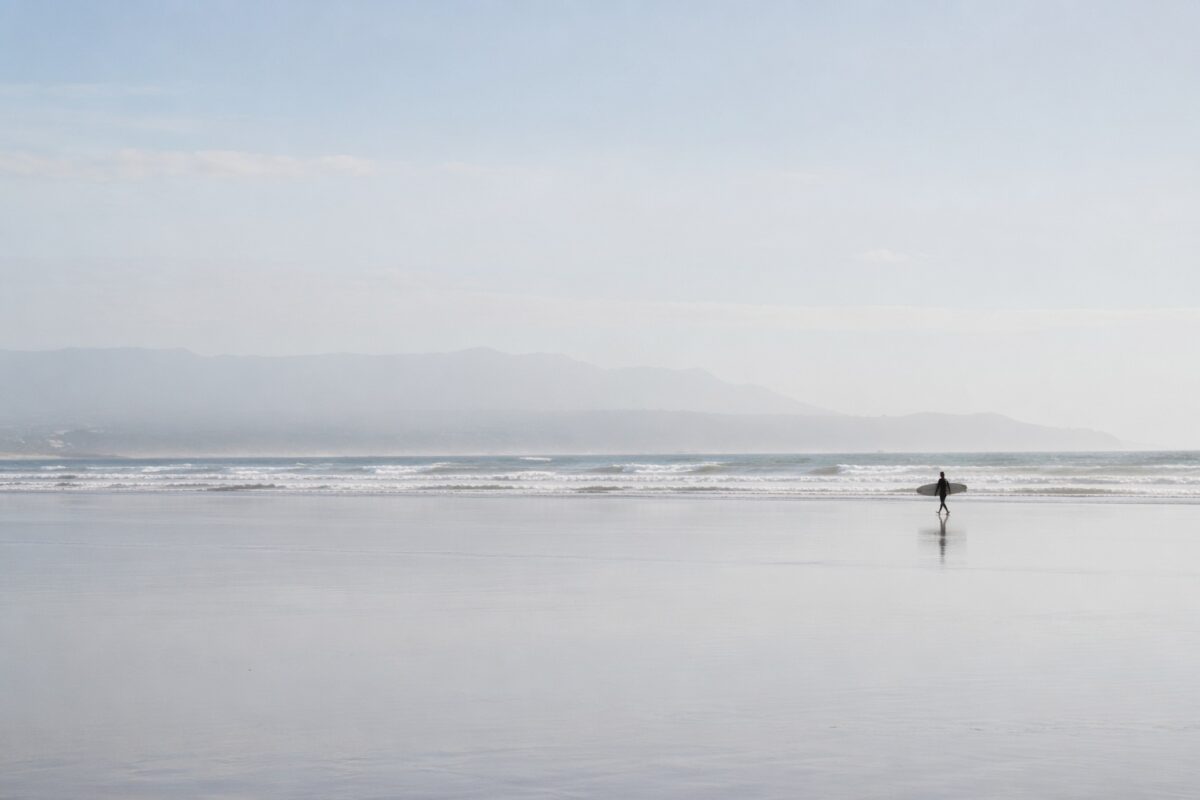 Minimal beach scene with a small subject and large clean negative space