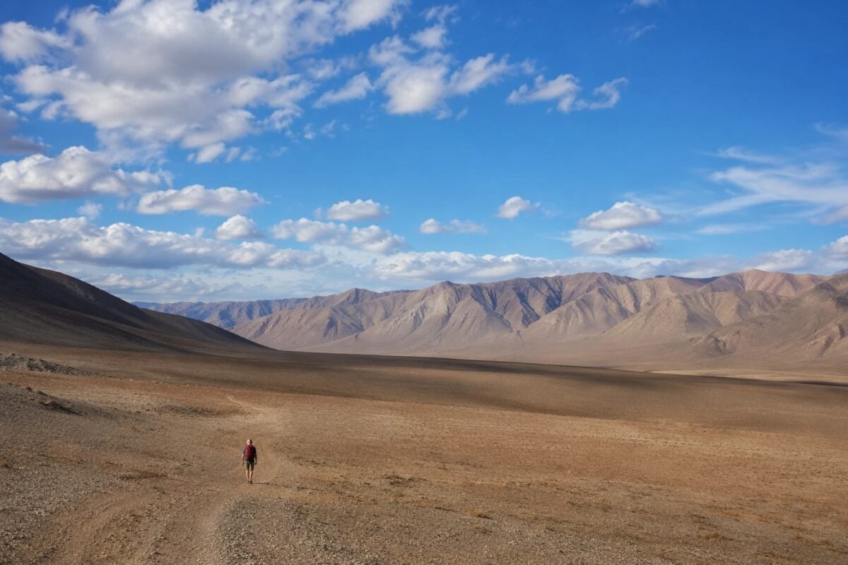 Small hiker in a wide landscape showing scale through negative space