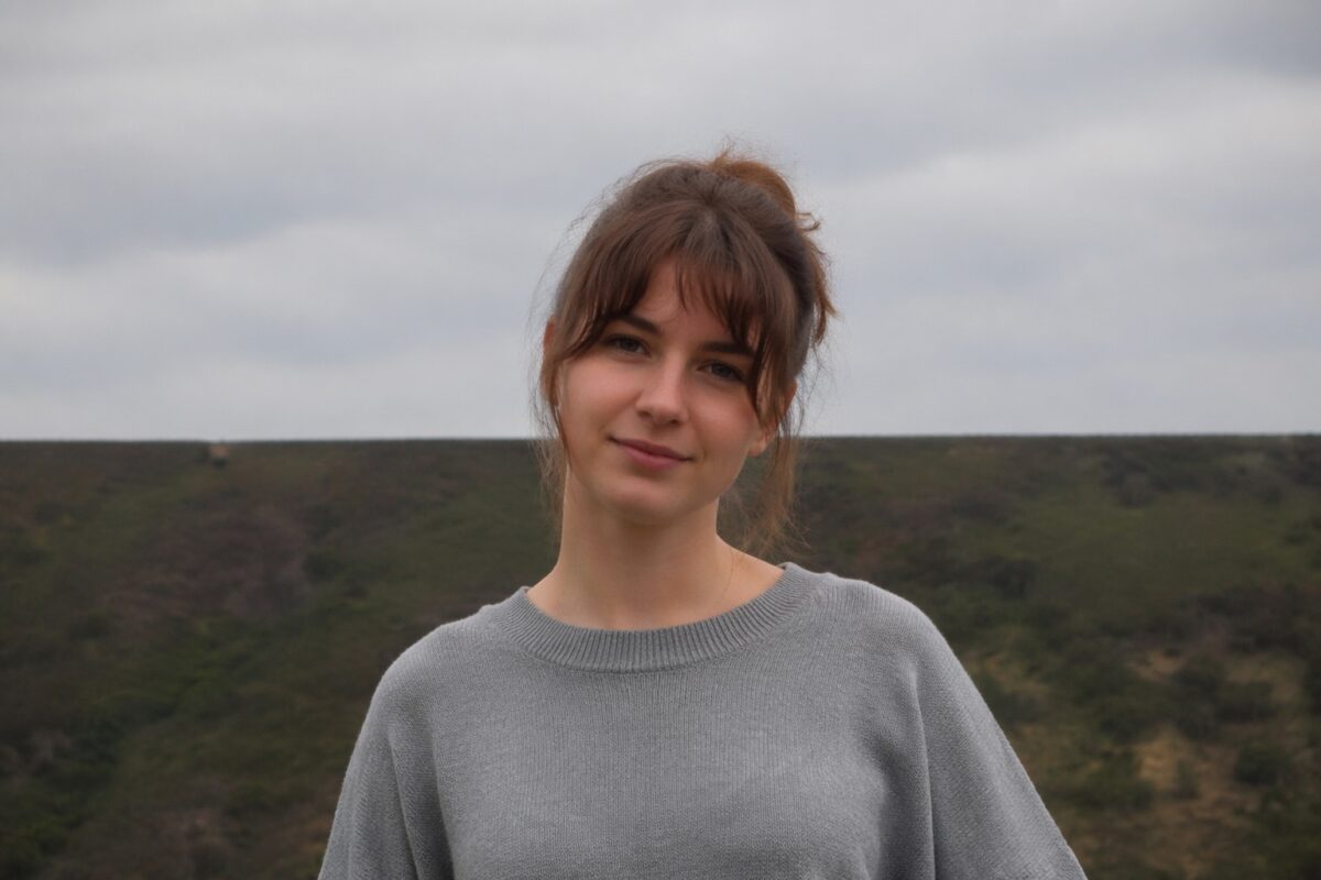 Environmental portrait where a background horizon line cuts awkwardly through the subject
