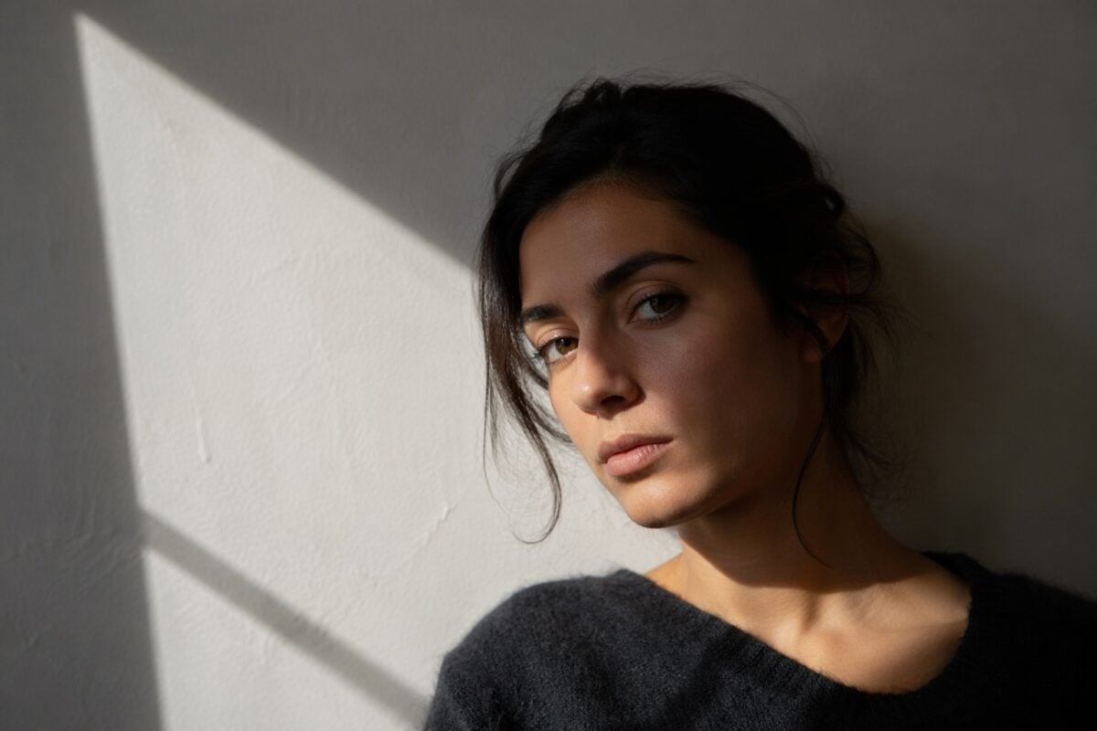 Light shadow and subject forming an implied triangle in a portrait