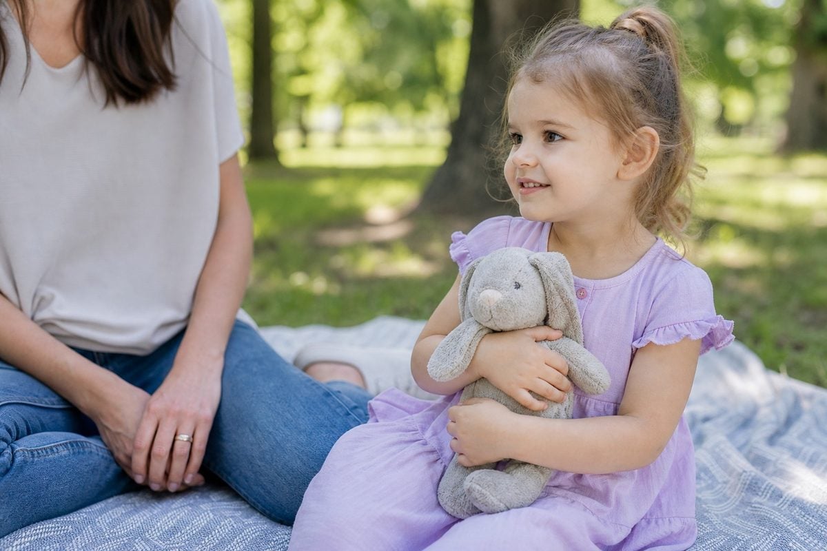 child pose natural hands Child portrait pose with natural hand placement holding a small toy
