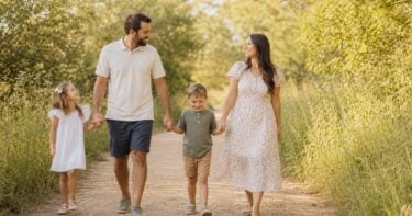 Family walking together in warm summer light during a relaxed outdoor photo session