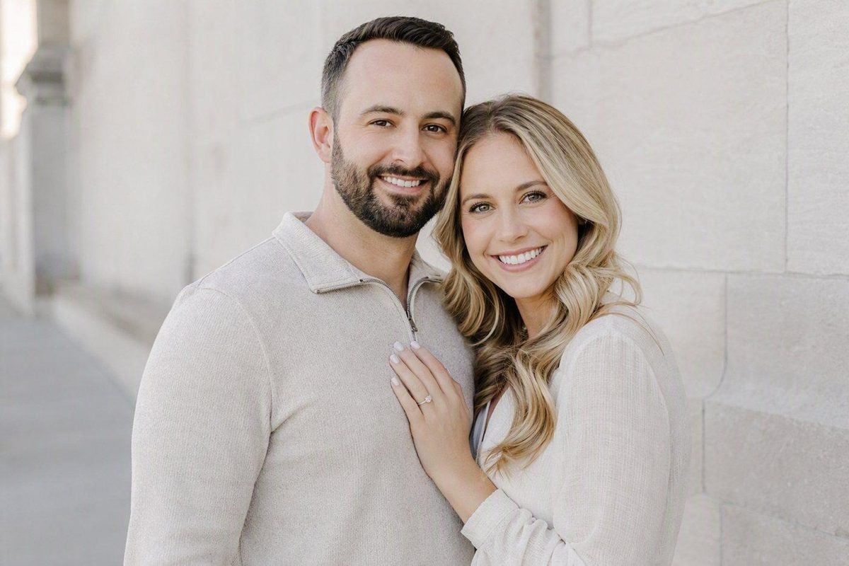 Engagement couple portrait in open shade with readable faces and clean background separation
